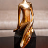 Abstract Gold Sitting Figurine on Black Cube Base